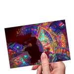 Load image into Gallery viewer, Hand holding a postcard-sized art print featuring a psychedelic house interior in a fisheye perspective. it has a vibrant but somehow musty color scheme. rooms intersect at impossible angles and some walls are missing, opening up to a huge black void. endless rooms and hallways fade into the distance. 
