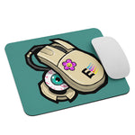 Load image into Gallery viewer, Mouse pad featuring a stylized drawing of a 90&#39;s era computer mouse, in that classic off-white color. the rubber ball is falling out the bottom, but its a big bloodshot eyeball! the background is the same shade of teal used as windows 95 default background color.
